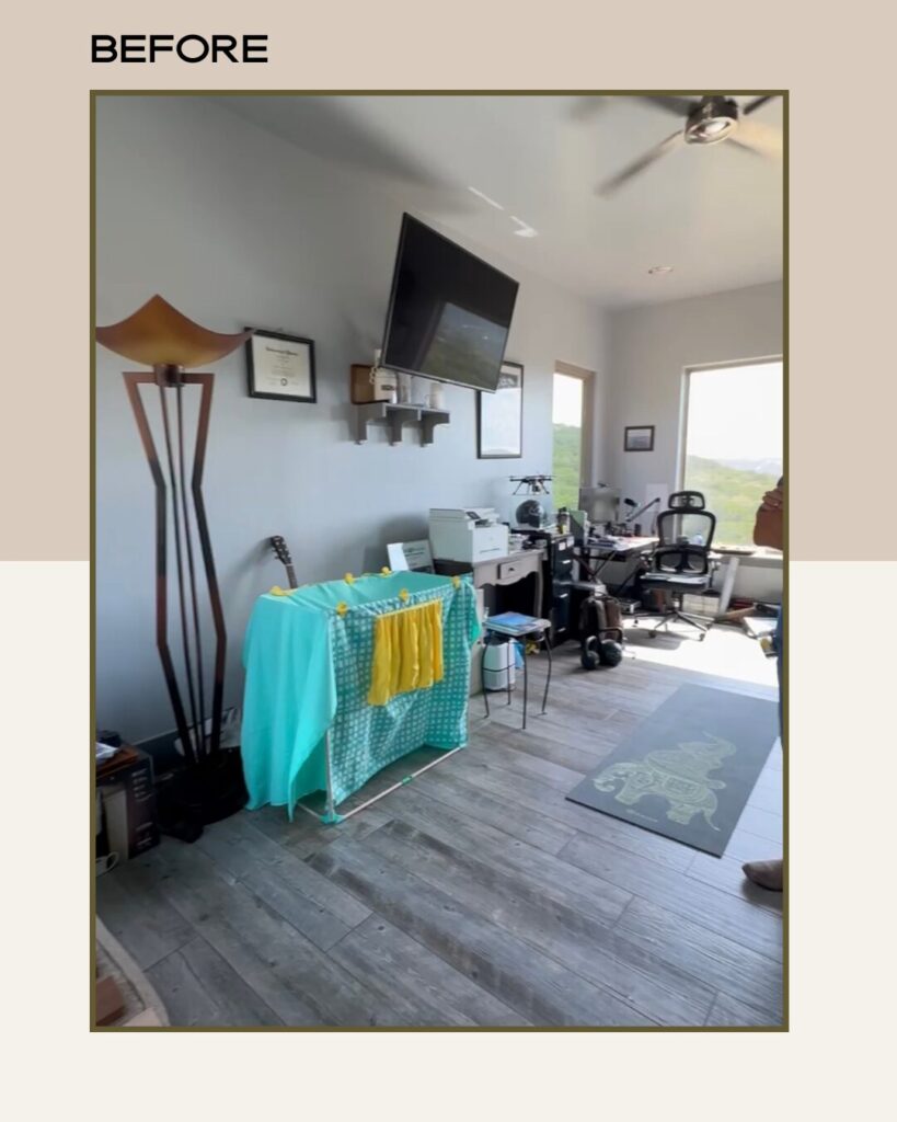 Cluttered room featuring a green and yellow laundry setup, a TV, office furniture, and natural light from large windows.