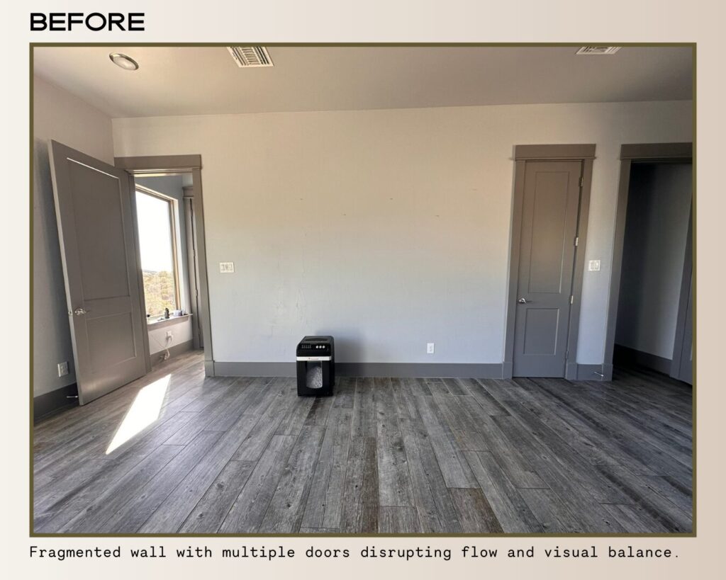 Empty room with a fragmented wall, multiple doors, and gray walls. Wood-style flooring disrupts visual balance and flow.