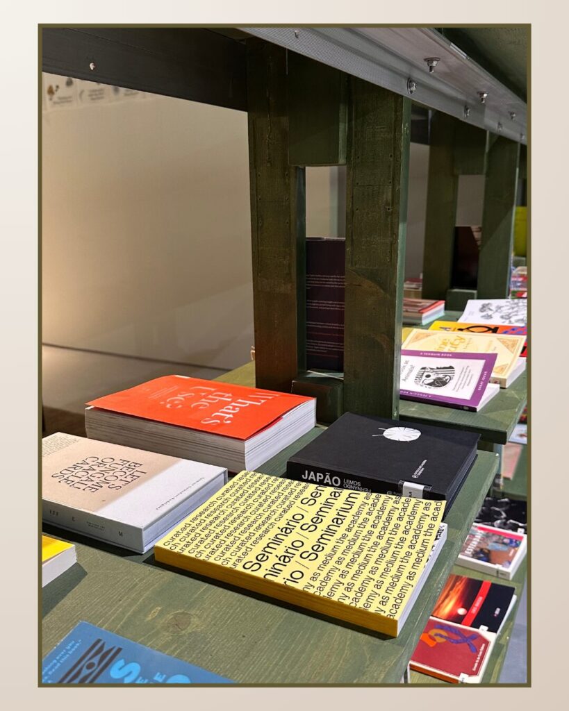 Colorful book display on a wooden shelf, featuring stacked books with diverse covers and titles, creating a vibrant study atmosphere.