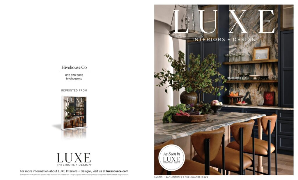 Sophisticated kitchen featuring a marble island, dark cabinetry, and stylish decor, highlighted in LUXE Magazine.